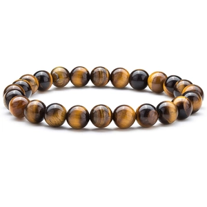 Macro shot of tiger eye stone beads showing natural golden brown textures and glossy finish