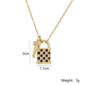 Detail of 18K gold plated lock and key pendant featuring checkered enamel and zircon inlay