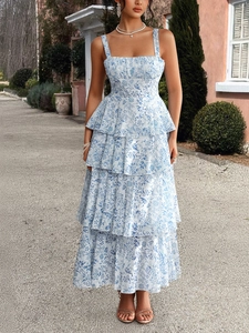 Detail of tiered ruffle hem on a white and blue floral chiffon maxi sun dress