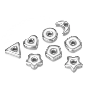 Macro view of silver geometric beads for DIY jewelry making on white background