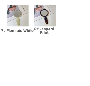 Detail of handheld acetate makeup mirrors in pearlescent white and classic leopard patterns