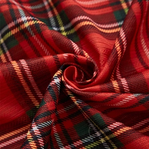 Classic red and green plaid Christmas curtain fabric with a soft festive drape