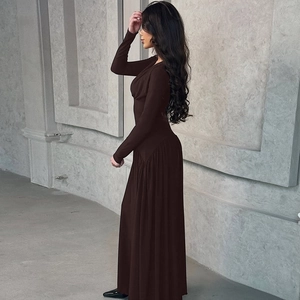 Detail of dark brown long-sleeve floor-length dress with a slim-fit waist and soft drape