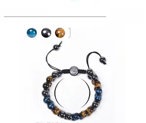 Macro detail of 8mm blue tiger eye and hematite beads on a woven adjustable bracelet