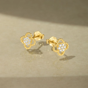 Macro shot of S925 sterling silver gold flower stud earrings with sparkling zircon inlay