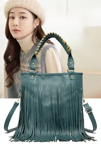 Detail of dark green cowhide fringe bag with woven chain handle and golden metal rivets