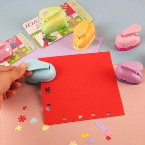Manual craft paper punches for kids DIY projects creating heart and star shapes
