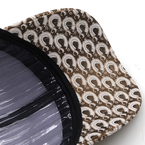 Close-up of baseball cap brim featuring fish scale leopard print and reinforced black piping
