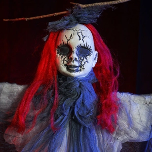 Scary Halloween grim reaper prop with red hair and cracked face under dramatic lighting