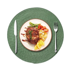 38cm round green woven placemat with cutlery and steak dish on a white background