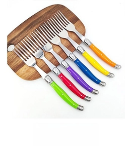 Laguiole style stainless steel forks with vibrant multi-color wood handles on board