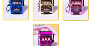 Miniature lucky slot machine keychains in metallic blue, gold, and rose pink finishes