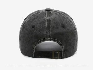 Detail view of washed vintage baseball cap with adjustable metal buckle and contrast stitching