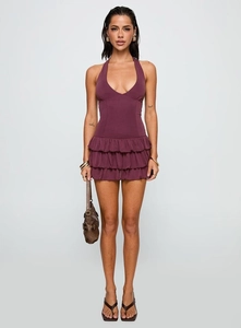 Detail of the deep purple halter neck dress featuring a tiered ruffle hem and slim fit