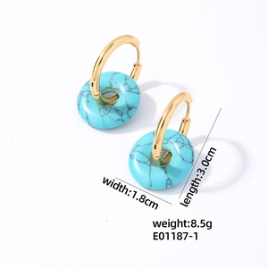 Gros plan de boucles d'oreilles créoles dorées avec turquoise bleue et dimensions