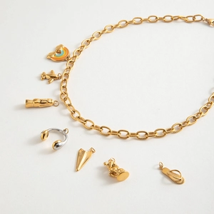 18K gold stainless steel twisted chain necklace featuring unique artistic charms on white background