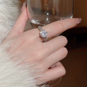 Close-up of a silver spinning snowflake ring with zircon stones on a soft background