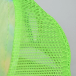 Close-up detail of neon green mesh fabric with honeycomb pattern for a trucker hat