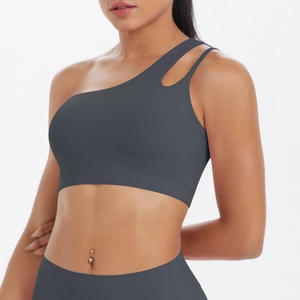 Detail view of charcoal gray one-shoulder sports bra with asymmetric cutout and brushed fabric