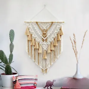 Detail of handcrafted bohemian macrame wall hanging with two-tone cotton fringe textures