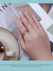 Detailed view of S925 sterling silver wing ring worn on hand with refined textures