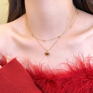 Double-layer stainless steel necklace with a red heart pendant and golden metal beads