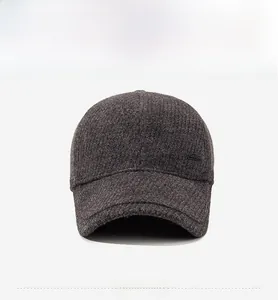 Front view of a dark grey winter baseball cap with thick wool texture and ear protection