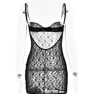 Detail view showing backless lace patchwork and adjustable strap of the black mini dress