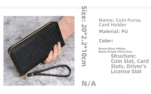Detail view of black PU leather long wallet with embossed rose patterns and wrist strap