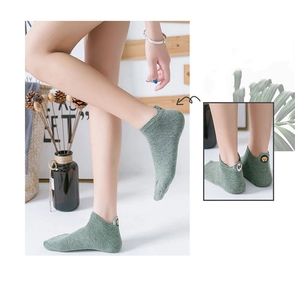 Detail of green cotton ankle socks with cute embroidered bear design on the heel