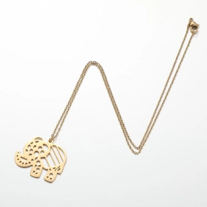 Detailed view of a gold elephant pendant with a geometric hollow-out design and lobster clasp