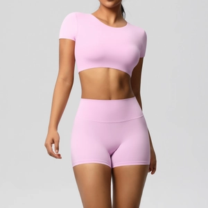 Detailaufnahme von rosa Yoga-Set mit High-Waist-Shorts und Crop Top aus glattem Stoff