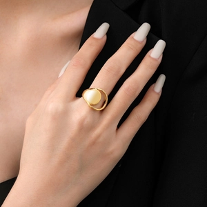 Minimalist geometric gold-plated open ring with beige gemstone on a female model