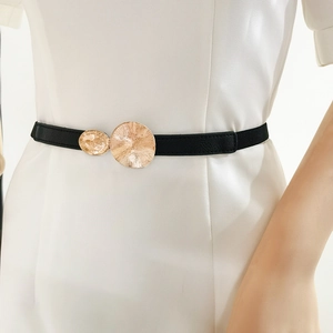 Women black thin elastic waist belt with textured gold metal buckles on white dress