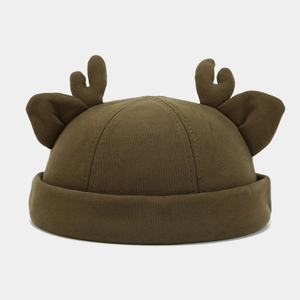 Detail of dark brown knitted deer beanie with 3D antlers and ears for autumn fashion