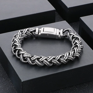 Detailed view of punk style stainless steel braided chain bracelet with square clasp