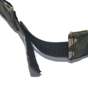 Detail of adjustable hook-and-loop velcro strap on camouflage outdoor visor hat