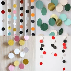 Detail of round paper glitter garlands in multiple color schemes for party decorations