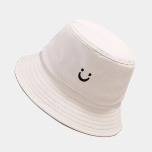 Minimalist beige canvas bucket hat with embroidered smiley face for outdoor sun protection