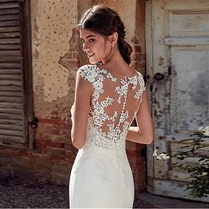 Elegant white lace mermaid wedding dress with sheer floral illusion back detail