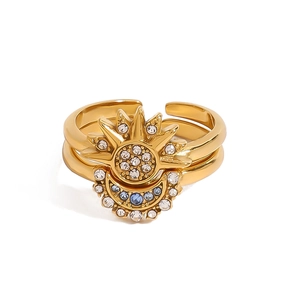 Golden sun and moon stacking ring set with blue and white crystals in stainless steel