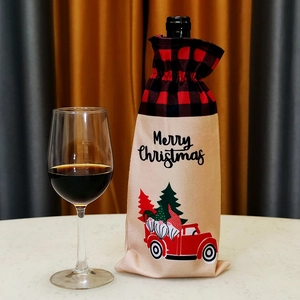 Christmas wine bottle cover with red truck and gnomes on a beige linen drawstring bag