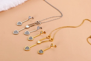 Macro detail of heart-shaped necklace and earring set with inlaid rhinestones and shell