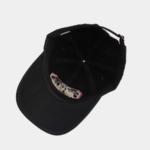 Classic black cotton baseball cap showing internal structure and adjustable metal buckle