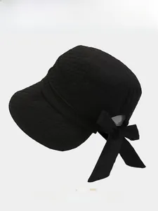 Detail showing the large bow and textured fabric on this foldable women's sun bucket hat