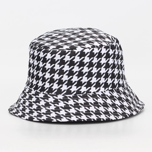 Close-up of classic black and white houndstooth pattern on a stylish bucket hat fabric