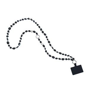 Ethnic irregular black beaded phone strap with silver rings on white background