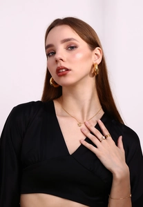 Close-up of 18K gold plated jewelry set featuring star and water drop zircon rings