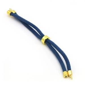 Detail of blue braided cord bracelet with adjustable gold metal slider and end caps