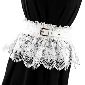 Detailed view of white floral lace corset belt with gold buckle on a black dress